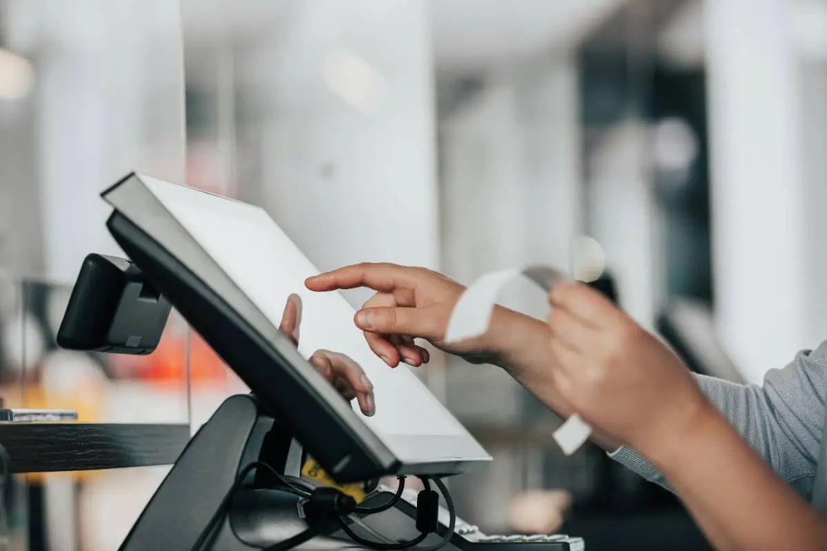 A customer paying at an Orbis point-of-sale touchscreen